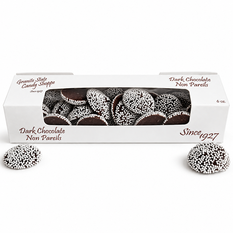 Dark chocolate nonpareils in a window box on a white background